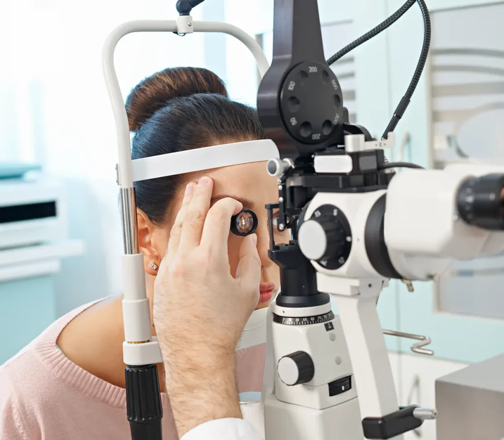 Doctor giving an in-depth medical eye exam to a patient using a medical device.
